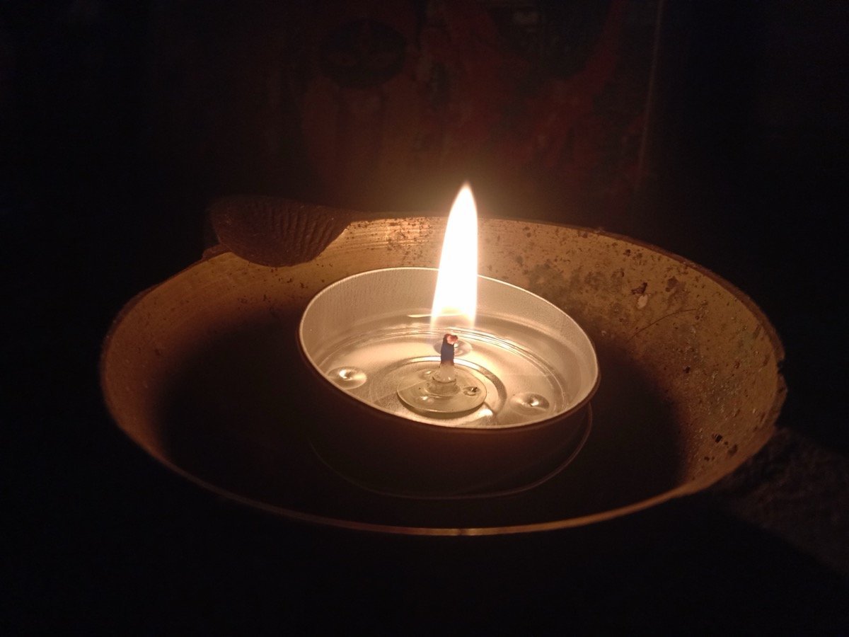 A single lit diya glowing warmly